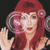 Pixelated image of a figure with long red hair wearing a red headband, holding a large circular object near the face against a dark background.