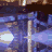 Pixelated text-based animation with repeated phrases over a blurred background of lights and figures.