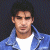 A pixelated image of a person in a blue jacket over white shirt against dark background with green text reading Original Icons .com on right side.