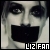 Pixelated close-up of a face with dark eye makeup, a wide black mouth, and light skin tones, with text reading 'LIZ FAN' at the bottom.
