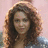 Pixelated image of a person with curly brown hair and red text reading "Beyonce Knowles in Obsessed out February 2009!" on white background.