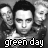 Animated contact sheet of a 48x48 pixel buddy icon featuring repeated grayscale portraits with green text "green day" across multiple frames showing subtle facial expression changes and color variations in the text.