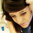 Pixelated close-up of a person with dark hair wearing a black hat and blue shirt, eyes closed in a serene expression.