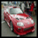 A red sports car with a blurred background appears next to bold black text on a bright red reading 'I Own The Streets' in pixelated font