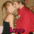 A pixelated image of a couple kissing, with a woman in a black dress and a man in a red shirt, overlaid with pink text reading "love".