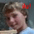 Pixelated close-up of a person with brown hair and light skin, red text 'ilu!' in top-right corner on dark background.