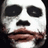 A pixelated face with white skin, black eye patches, and brown lips in a