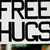 Pixelated black-and-white text reads "FREE HUGS" with a small green pixel cluster near the bottom right of the image.