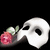 A white mask with black eye sockets holds a pink rose with green leaves against a solid black background.