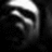 A grayscale pixelated image of a stylized face with prominent eyes and a bright light source above, set against a dark background.