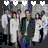 Animated icon of two figures in formal attire embracing, with heart symbols above their heads changing color from white to blue.