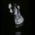 Pixelated grayscale image of a light-colored object with rounded and elongated shapes against a dark background, appearing as a stylized figure or abstract form.
