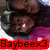 A pixelated image shows a person with dark hair and brown skin wearing a purple garment, overlaid by red text reading "Baybeex3" on a white background.