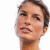 Pixelated close-up of a person's face with short dark hair, light skin tone, and neutral expression against white background.