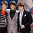 Three young men in formal attire stand side-by-side against a blurred background, with cyan text reading "They Are Why I LME III" on dark red.