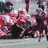 Pixelated image of football players in red uniforms tackling on a field with bold red text reading DUKE FOOTBALL IS BEASTLY!!! 50.