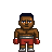 Pixel art of a muscular boxer with brown skin, dark blue hair, red shorts, and red boxing gloves standing against a gray background.