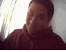 A person in a maroon hoodie appears in three showing facial expression changes from neutral to smiling