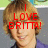 Pixelated image of a person with light brown hair wearing dark clothing, overlaid with red text reading "I LOVE BRITTA!" against a blurred background.