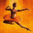 A ballet dancer in a red tutu leaps against an orange background, with a grayscale version showing the same pose.
