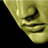 Static close-up of a golden mask with visible pixelation and dithering on black background.