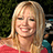 A pixelated image of a smiling woman with blonde hair on the left, next to blue text reading "HEY HILARY" and "YOU ROCK" on a bright pink background.