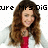 Pixelated image of a person with long brown hair wearing a red top and white jacket, with text above reading 'Your Mrs.Dig' on a white background.