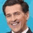 A pixelated portrait of a smiling man in a dark suit and white shirt against a light blue background, with red text reading "The President Of The UNITED STATES" on a solid blue field.