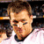 A pixelated image of a person in a white jersey with black trim, overlaid with bold text blocks reading "Tom Bady is The" and "Hottest Man Alive!" on separate sections.
