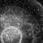 Grayscale pixelated image with dark background and light central shape resembling a rounded form or abstract figure.