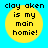 Yellow circular icon with black text on blue background, displaying "clay aken is my main homie!" in pixelated font.