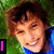 A person with brown hair and blue clothing smiles against a green background, with text elements changing across frames.