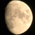 A pixelated circular image of a full moon with visible crater patterns against a black background.