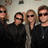 Four people in dark clothing pose together under green text reading 'BON JOVI' and 'FOREVER ALWAYS!!! N a day!!'