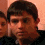Four of a person with short dark hair in a black shirt against a light brown background, showing head and eye movement across the sequence