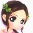 Pixelated anime-style character with brown hair, green floral accessory, large dark eyes, and pink clothing visible at the bottom edge.