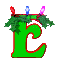 Green stylized letter E with red outline, topped by green foliage and three colored lights (red, blue, pink) on gray background.