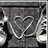 Pixelated grayscale icon with abstract white line shapes on a dark background, featuring vertical black bars and scattered light pixels.