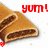 A pixelated food item with a brown exterior and dark filling, accompanied by red text reading "yum!" on a white background.