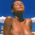 A pixelated image showing a shirtless person with short dark hair against a blue sky background on the left, and green text reading "Original Icons .com" on a solid green background on the right.