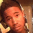 Pixelated close-up of a person with light skin tone, dark hair, and closed eyes against warm-toned background.
