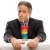 A person in a black jacket over a rainbow-striped shirt sits with hands clasped against a white background.