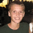 A pixelated image of a person in a dark shirt with a black background and yellow accents, showing text overlay changes.