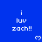 Blue background with repeated white pixel text 'i luv zach!!' and small white heart symbols arranged in a pattern