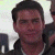 A pixelated image of a person with short dark hair wearing a dark jacket over a light shirt, next to green text reading 'Original Icons .com' on a solid background.