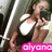 A person in a black and white top holds a camera, with pink text overlay reading 'aiyana' across the lower portion.