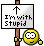 Pixel art buddy icon featuring a yellow smiley face holding a sign with text and an arrow on a gray background.