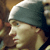 Static 50x50 pixel icon showing a close-up profile of a person wearing a gray beanie, with visible facial features and blurred background elements.