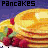 Pixelated image of stacked pancakes with butter and raspberries on a plate, next to green text reading 'Original Icons .com' against a dark background.
