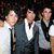 Group of young men in formal and casual attire with one holding a microphone, three close-up portraits below showing different expressions.